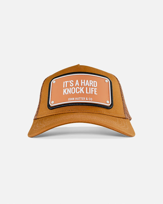 It's A Hard Knock Life Rubber Trucker Cap by John Hatter & CO